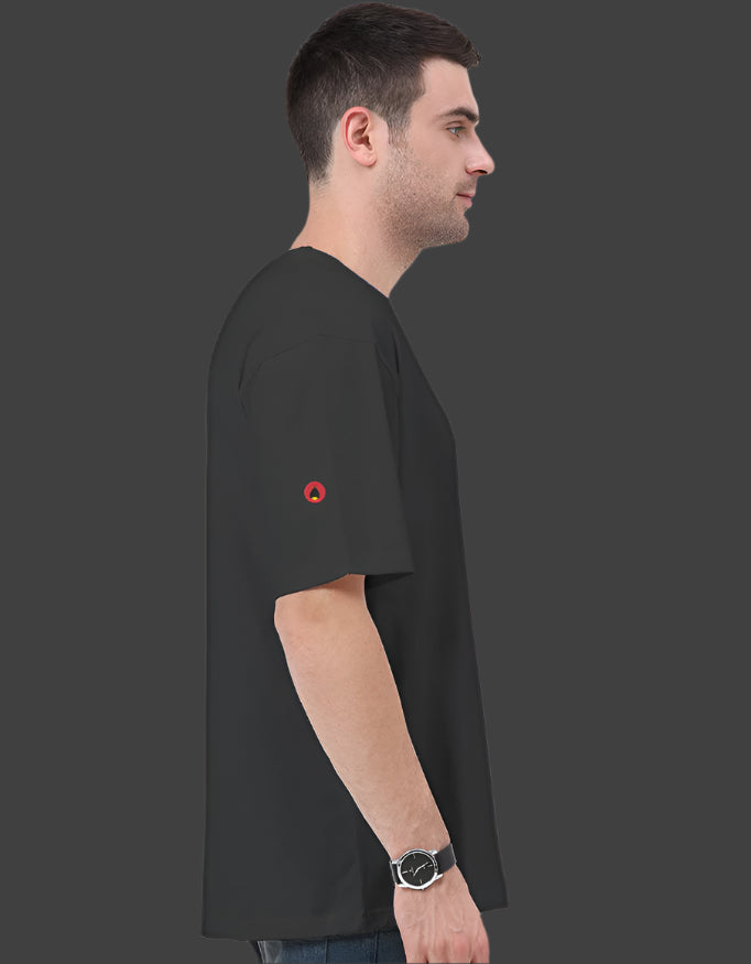 Man wearing a black t-shirt with a red logo on a dark background
