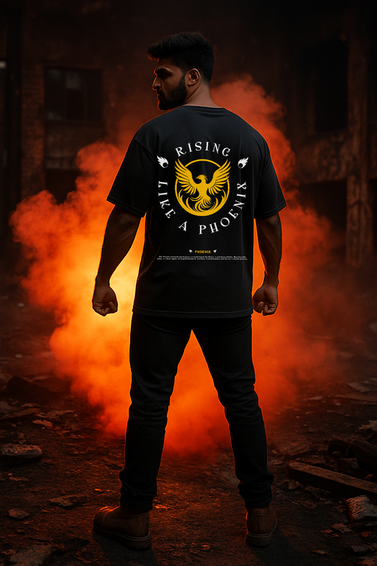 Person wearing a black t-shirt with a phoenix design in front of orange flames