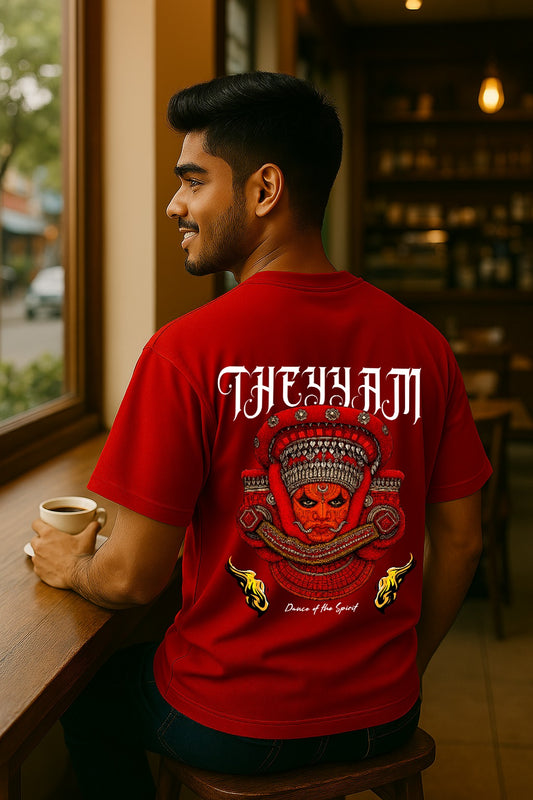Man wearing a red t-shirt with 'THE HAM' design, sitting at a table in a cafe.